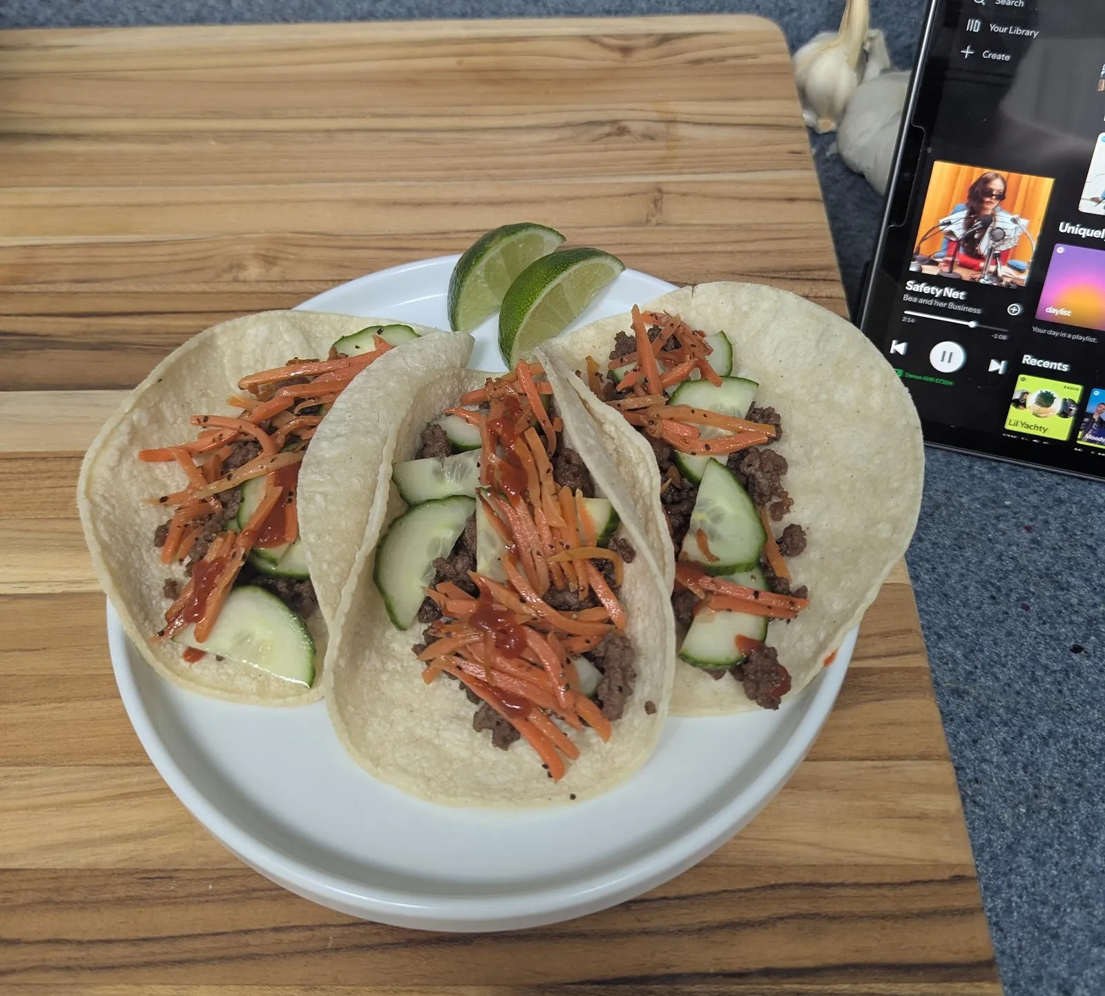 Beef tacos topped with pickled carrots, cucumber and cilantro