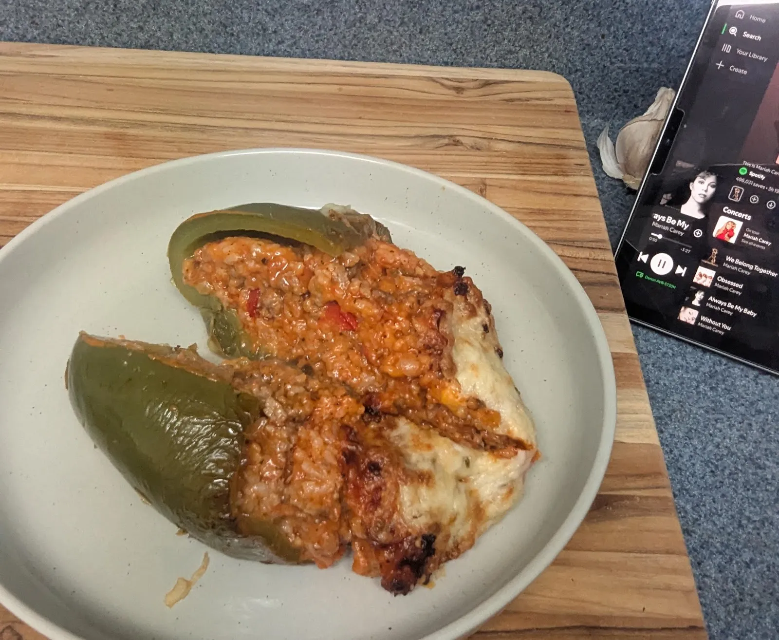 A green bell pepper stuffed with meat and rice under melted cheese