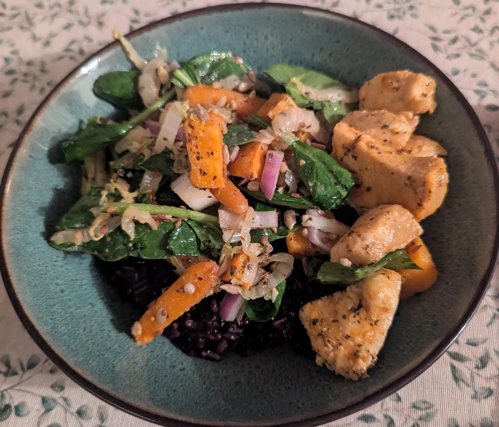A wild rice harvest bowl with roasted squash and greens