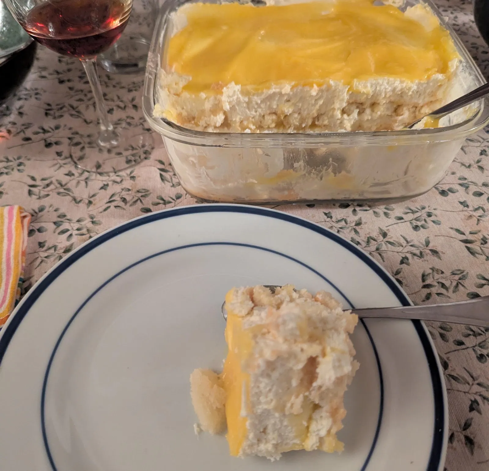 A slice of lemon tiramisu beside the dish