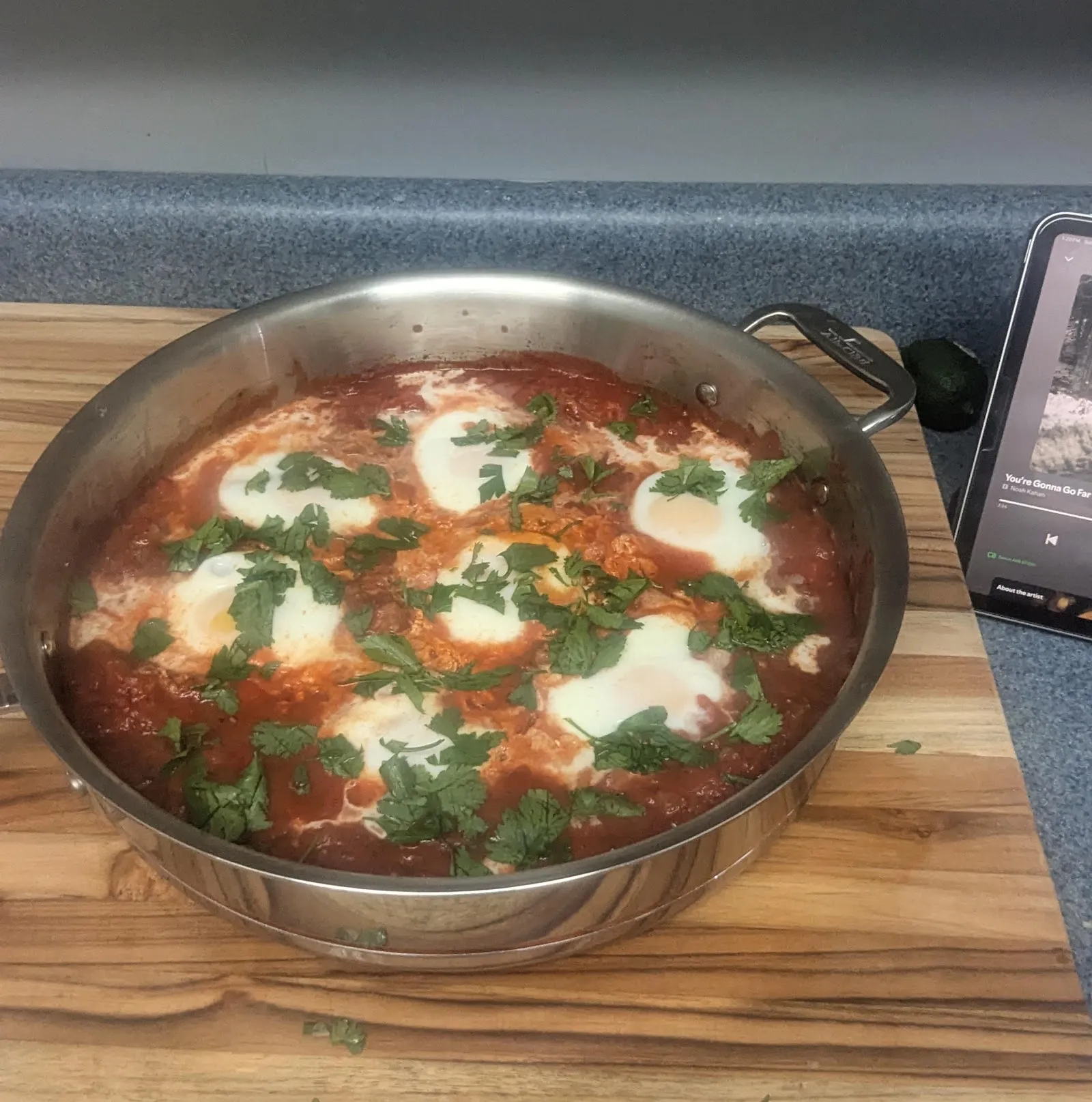 A skillet of shakshuka with eggs nestled in spiced tomato sauce